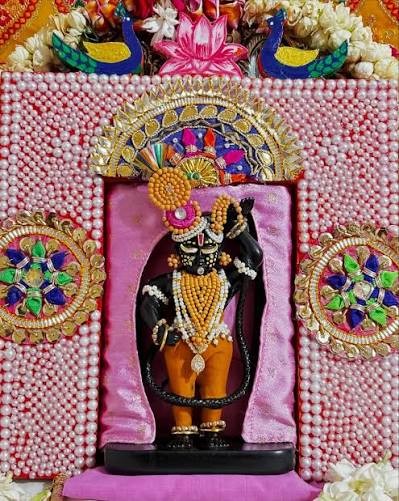 Shri Radha Girdhar Lal Ji darshan with a pearl-work backdrop